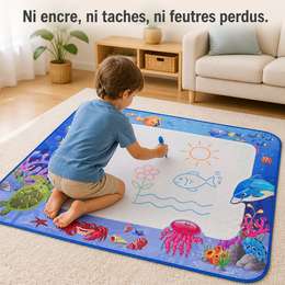 Un enfant dessine sur le tapis avec un stylo à eau